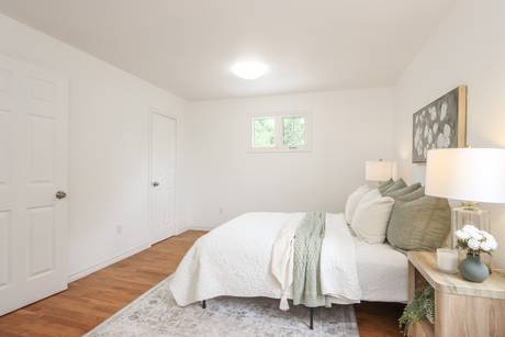 Bedroom with a bed, side table and a piece of wall art