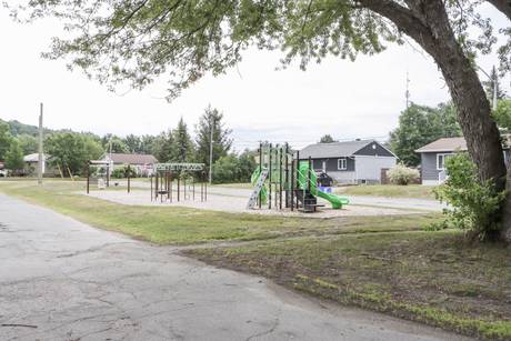 Community playground with slides and swings on an overcast day